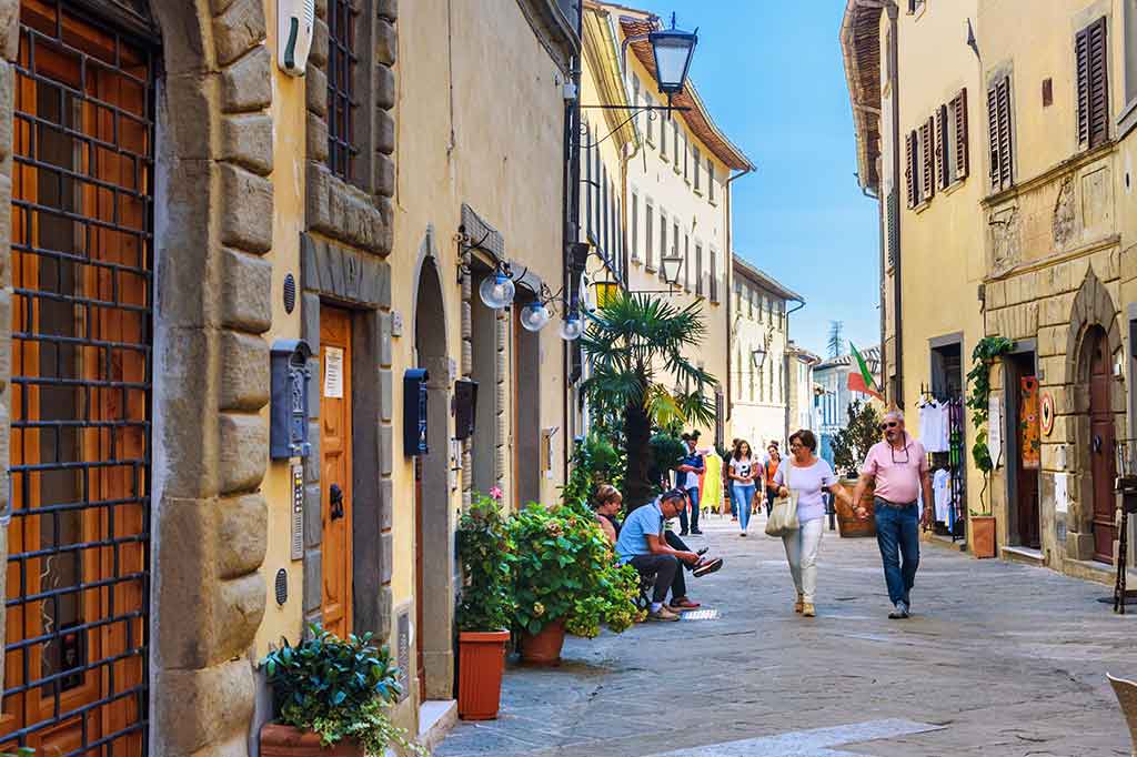 Castellina in Chianti, Siena, tourists strolling in the historic center Castellina in Chianti, Siena, tourists strolling in the historic center