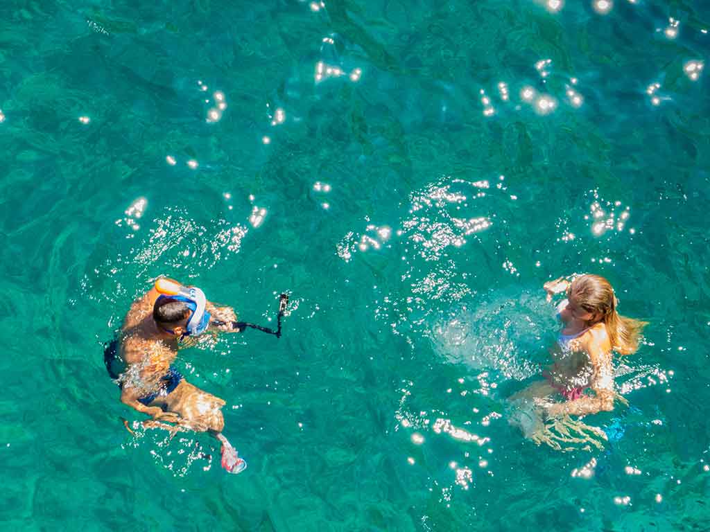 Bathers in the clear waters of Gagliano del Capo