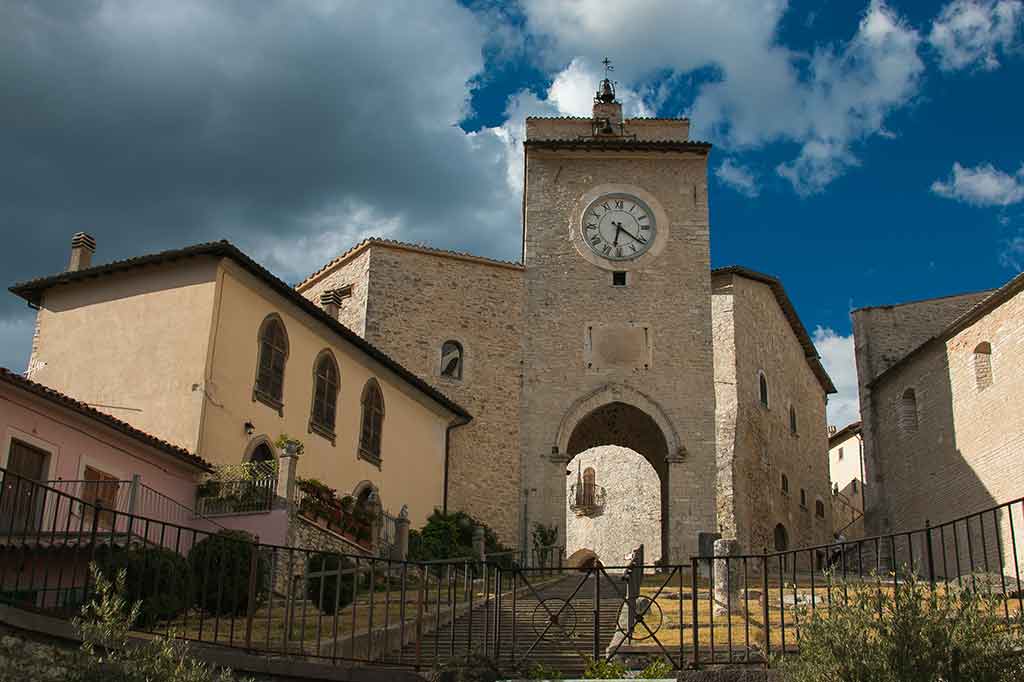 Historical building with arch and clock in Monteleone di Spoleto, Perugia